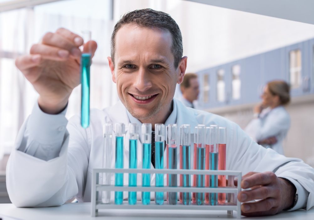 smiling-medical-worker-in-white-coat-working-with-MS4TJTU.jpg